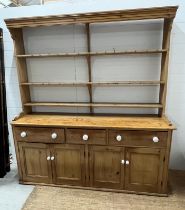 A pine kitchen house dresser with open plate rack, drawers and cupboard to base (H223cm W202cm