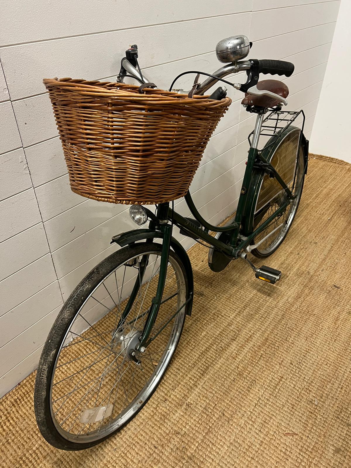 A ladies push bike by Princess, wicker basket to front and Brooks leather seat