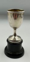 A miniature silver cup on stand, hallmarked for Birmingham