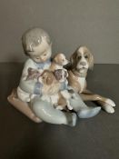 A boxed Lladro figure of a boy with puppies Condition Report good condition