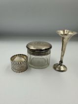 Hallmarked silver to include a napkin ring, spill vase and glass jar with silver lid