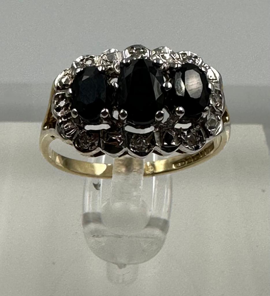 A 9ct gold diamond and sapphire ring, approximate size M1/2