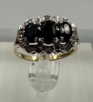 A 9ct gold diamond and sapphire ring, approximate size M1/2
