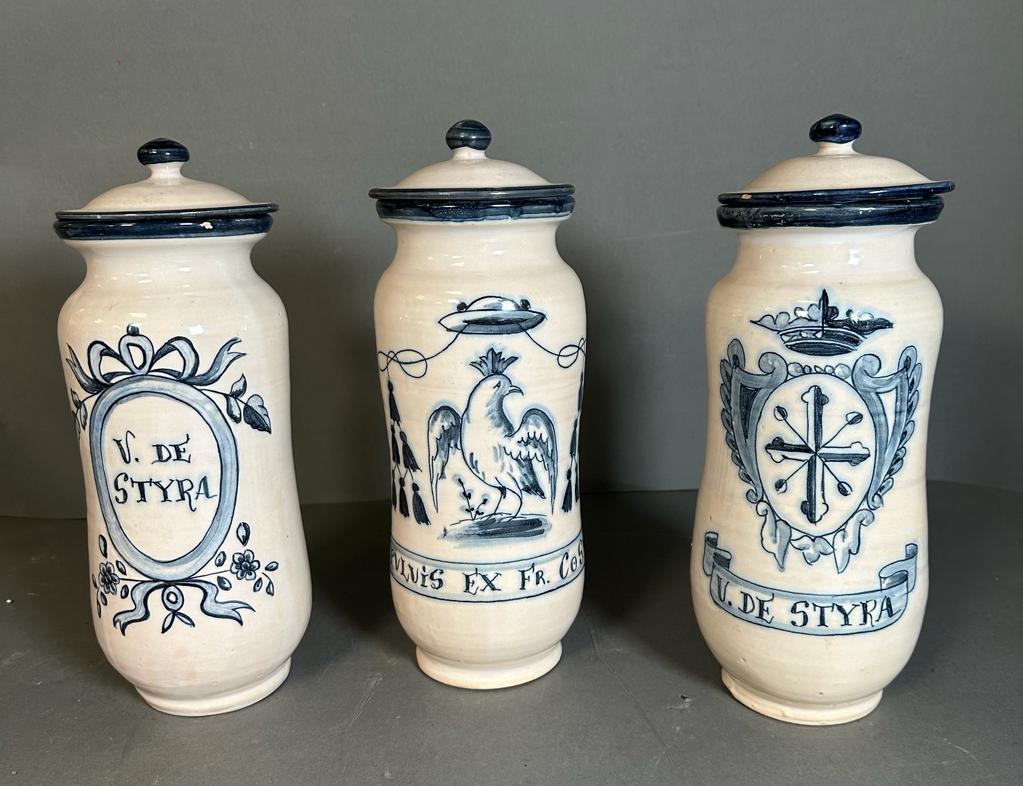 Three lidded blue and white jars with Latin inscription