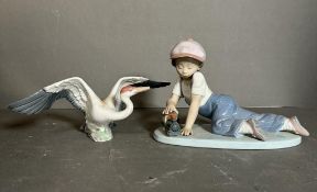 Two Lladro figures, a boy with a train and a goose Condition Report The goose is missing some of its