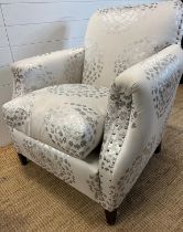 A contemporary Easy chair or bedroom chair with a dove grey blossom print upholstery