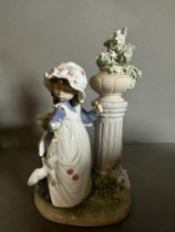 A large boxed Lladro figure of a young girl by a floral column Condition Report good condition