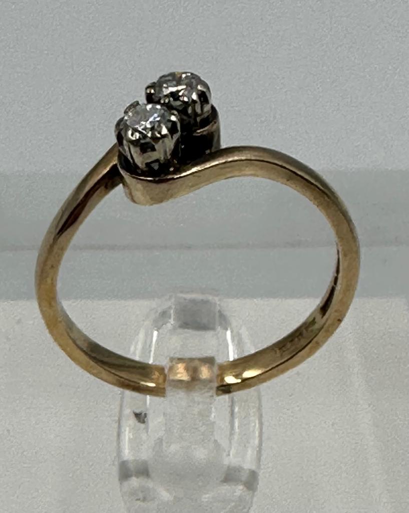 A two stone diamond ring on a 9ct gold setting, approximate size P and weight 2.6g.