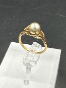 An untested gold and pearl ring, approximate total weight 2.1g. Size L