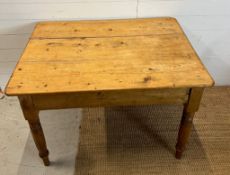A small pine farmhouse table with drawer to one end (H74cm W106cm D79cm)