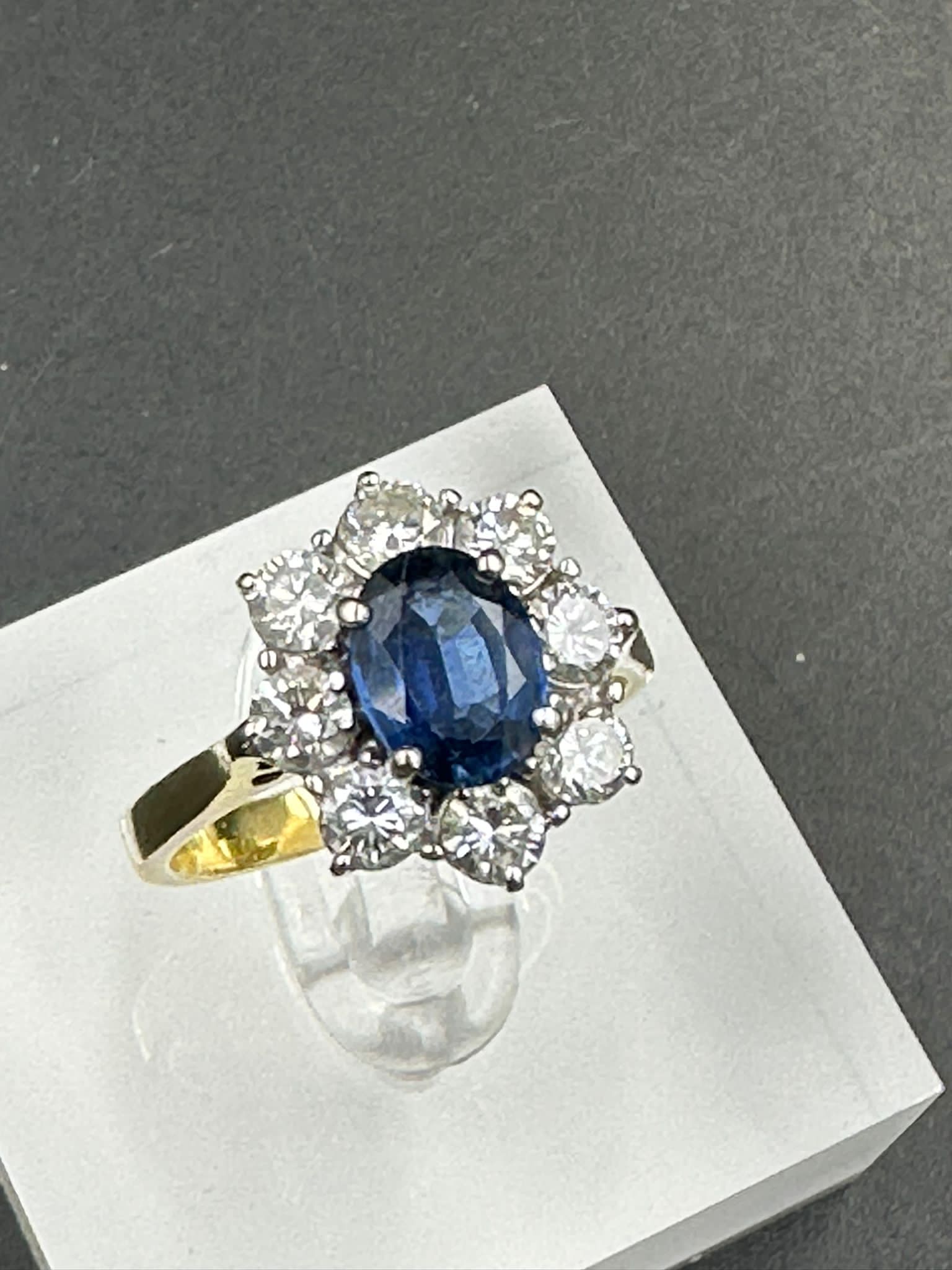 A sapphire and diamond cluster ring on an 18ct (750) shank. - Image 4 of 4
