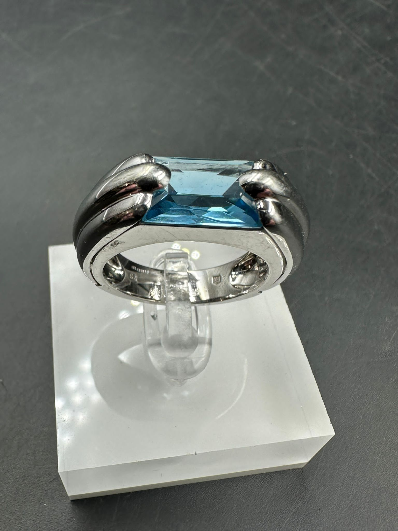 A single stone Audemars Piguet ring consisting of a rectangular mixed cut blue topaz stone (12.1mm x