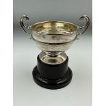 A two handled trophy on stand Approximate Total Weight 84g, hallmarked for Birmingham 1931 by