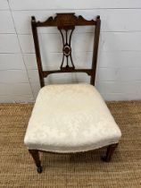 A slipper chair with pierced back AF