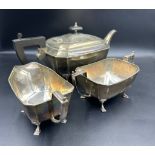 A silver three piece tea service to include teapot, sugar bowl and milk jug in an Art Deco style,