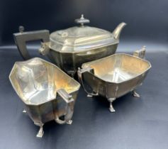 A silver three piece tea service to include teapot, sugar bowl and milk jug in an Art Deco style,