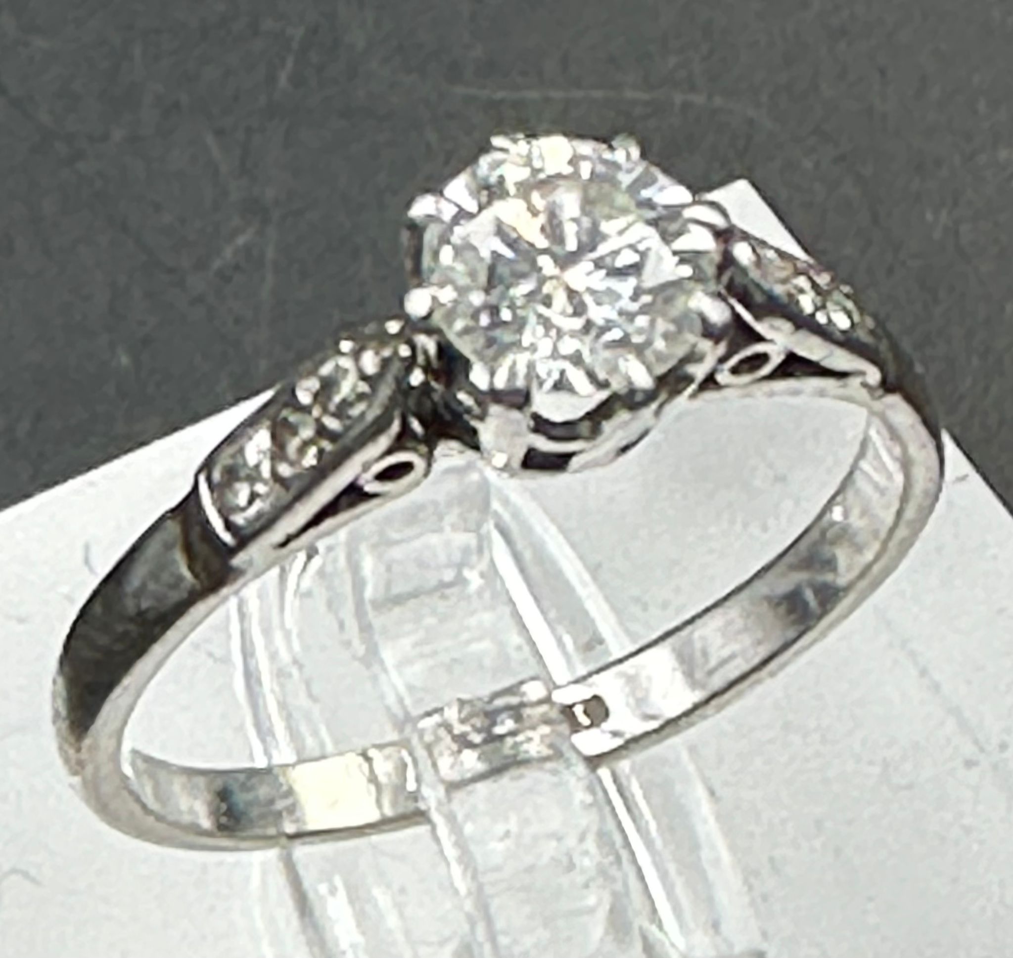 A single stone diamond ring with diamond set shoulders. Round Brilliant cut diamond 0.64ct, Colour - Image 6 of 6