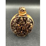 A Chinese hand carved resin snuff bottle depicting the Immortals