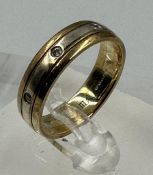 A 9ct gold band with diamond insets, approximate total weight 4.3g and size N