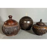 A selection of four wooden carved lidded pots