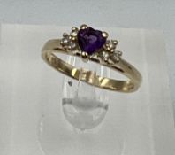 A 14ct gold amethyst and diamond shoulders with a heart shaped central stone on a 14ct yellow gold