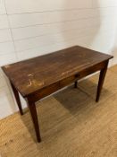 A mahogany side table on tapering legs and draw to centre. 116cm x d 62 x 75 h