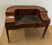 An Edwardian style Carlton house desk with brass galleried top, string inlay and tapering legs (