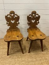 A pair of carved oak folk chairs or black forest chairs
