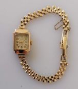 A ladies Majex dress watch with 9ct gold case and strap, overwound, hallmarked, 8.7g