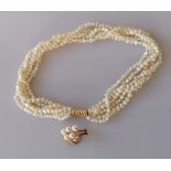 A five-strand pearl choker with a yellow gold clasp, stamped 585, 40 cm