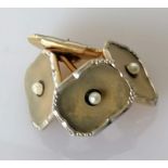A pair of white and yellow gold cuff links with seed pearl decoration
