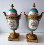 A pair of 19th century Sèvres twin-handle ormolu decorated garniture lidded urns