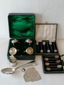 An assortment of silverware to include a near pair of Georgian serving spoon with bright-cut decorat