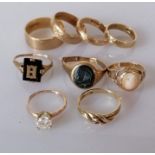 A selection of five gem-set rings, two cut, and four gold bands