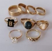A selection of five gem-set rings, two cut, and four gold bands