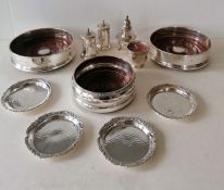 A pair of silver bottle coaster with wood turned inserts, each 13 x 4 cm and another smaller