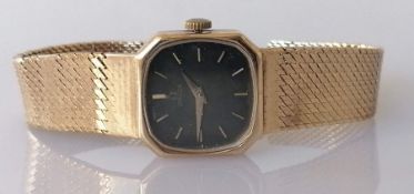 A vintage ladies Omega watch with 9ct gold case and herringbone strap, not in working order, 26g wit