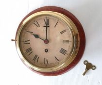 A mounted Smiths brass-framed ship's clock with Roman numerals, dial 16.5 cm, in working order