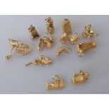 An assortment of 9ct yellow gold charms, some articulated, all hallmarked, 34.7g and two stamped 750