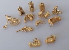 An assortment of 9ct yellow gold charms, some articulated, all hallmarked, 34.7g and two stamped 750