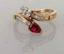 An Italian diamond and ruby crossover ring on a yellow gold setting