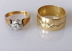 A mid-century diamond and gold flower ring on a textured shank