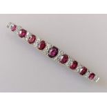 An Art Deco ruby and diamond bar brooch on a white gold setting