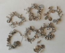 A selection of six silver charm bracelets, 554g