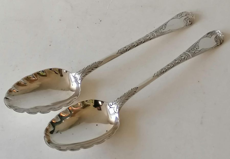 An assortment of silverware to include a near pair of Georgian serving spoon with bright-cut decorat - Image 2 of 2