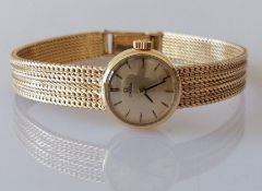 An Omega ladies manual-wind dress watch with gold dial, baton markers