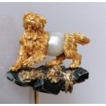 A gold terrier pearl stock pin brooch