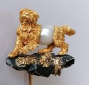 A gold terrier pearl stock pin brooch