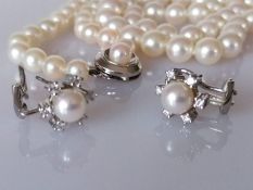 A pair of pearl-mounted white gold earrings, stamped 750, 6.2g and a choker single string of pearls