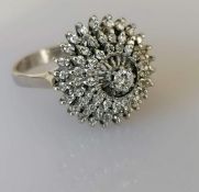 A white gold diamond cluster ring in a claw setting
